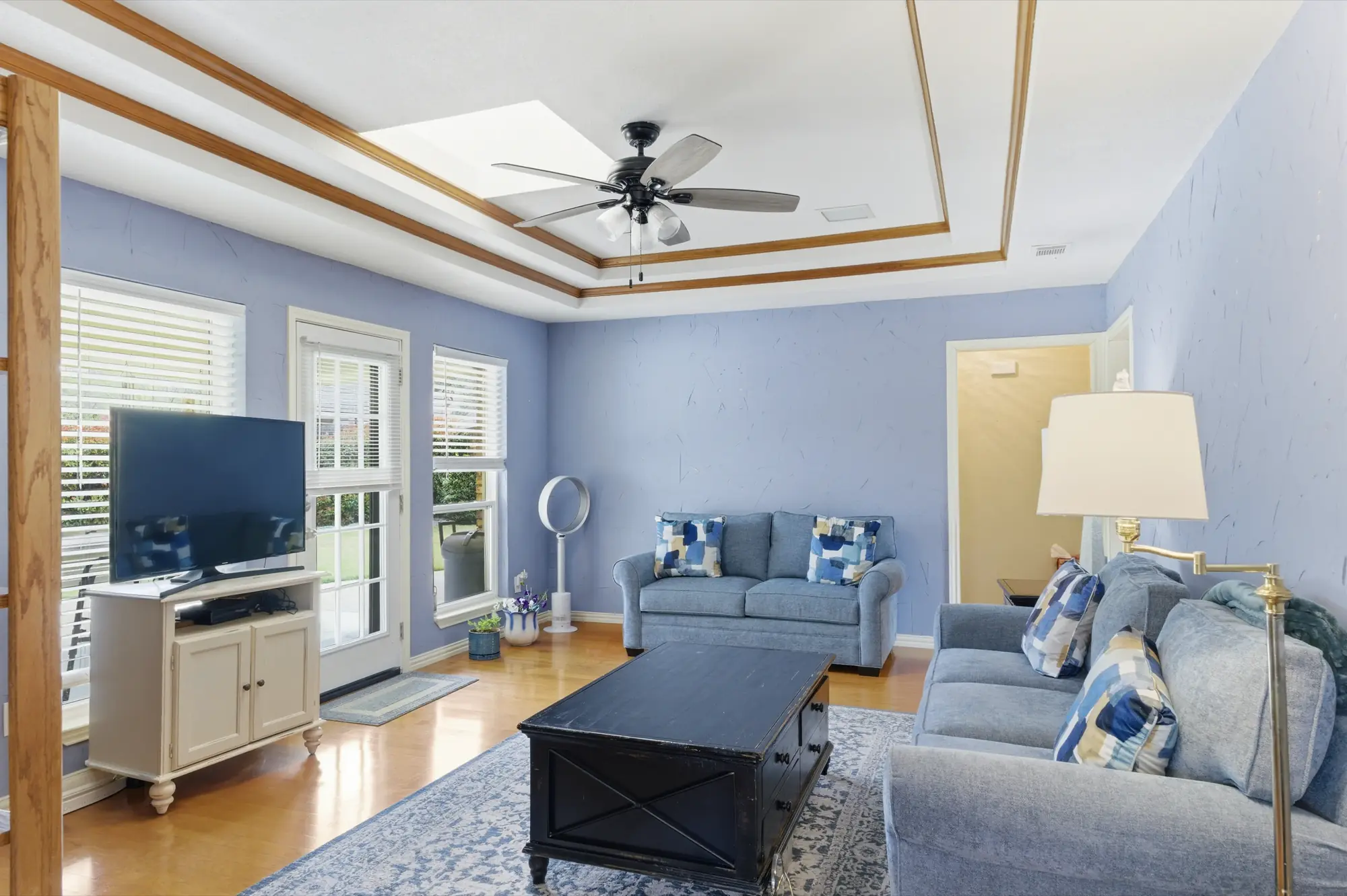 Family room with tray ceiling and wood trim